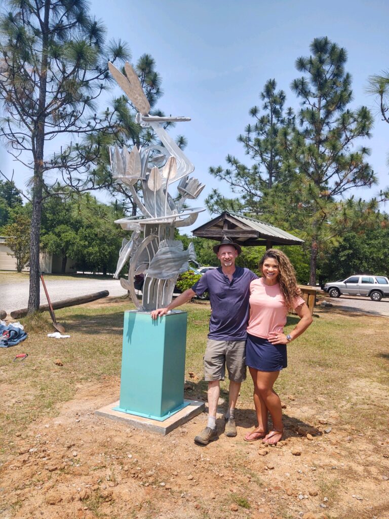 Photo of artist David Sheldon and Executive Director of Phinizy Nature Center, Alicia Sweat, with sculpture "Eco Friendly" installed at the Phinizy Nature Park on May 18, 2022