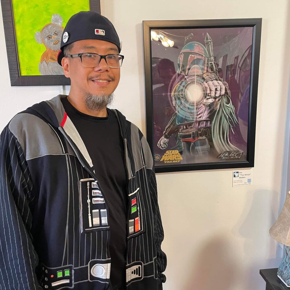Art the Artist Abdon in front of his Star Wars themed artwork at the May the 4th Be With You art Showcase in 2022