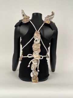 Back side of Oyster Armor sculpture. Oyster shells line the back with strings to tie armor around the torso.