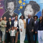Photo of the Walker family in front of the Golden Blocks mural