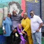 Photo of the Crawford family in front of the mural