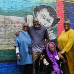 Photo of the Crawford family in front of the mural