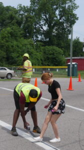 Photo of student gridding crosswalk for painting