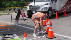 Photo of Augusta artist Leonard "Porkchop" Zimmerman helping paint crosswalk
