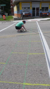 Photo of crosswalk being gridded out for painting
