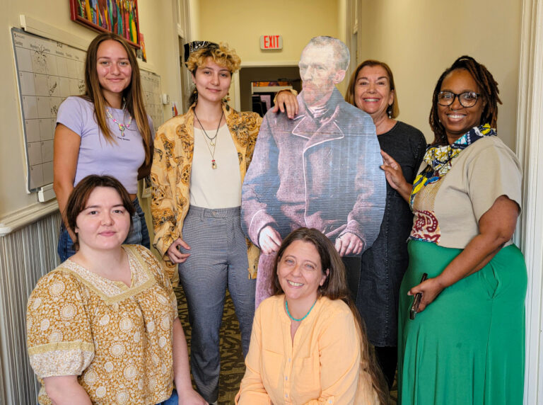 Galadra and the Arts Council staff posing with a cardboard cutout of Vincent van Gogh