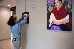 Galadra helping hang a gallery