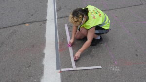 Galadra helping grid the East Augusta crosswalk mural