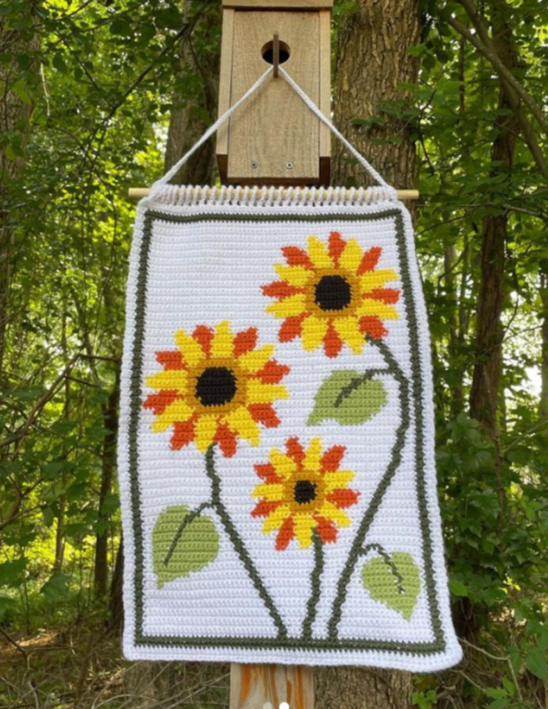 a crocheted tapestry of sunflowers