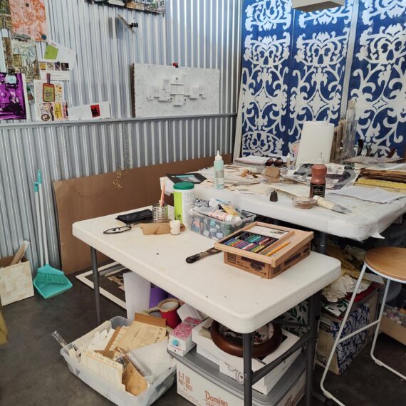 Photo of an art studio with works in progress on a table
