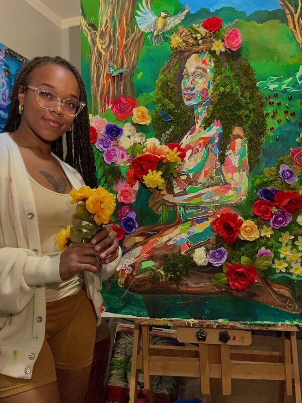 An African American young woman standing with her artwork. A portrait of a woman surrounded by flowers.