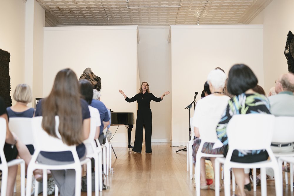 woman singing to a crowded room