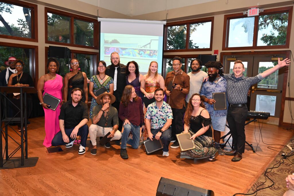 A group photo of artists winning an award