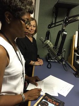 an African American woman hosting a podcast in a recording studio