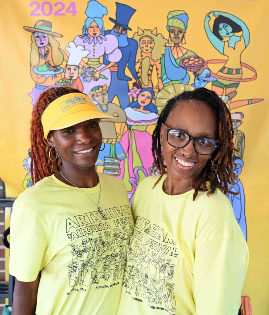 Two African American women wearing yellow smiling together