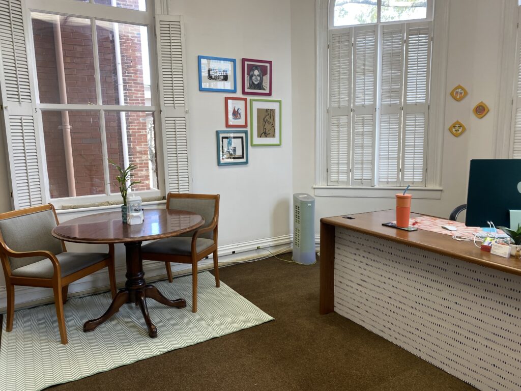 Photo of Heather Dunaway's office featuring colorful artwork on the walls