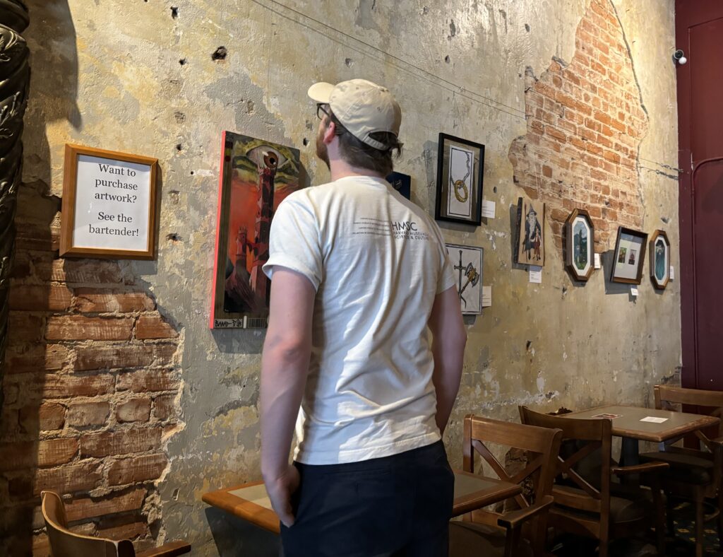 Caucasian Man admiring artwork in a gallery