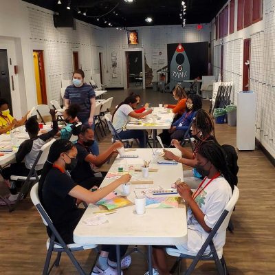 Heather Dunaway teaching watercolor to a class of students ranging from 11- 16 years old